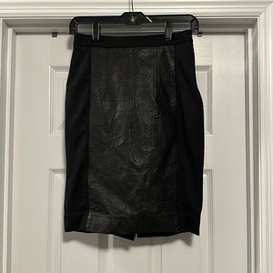Black high waisted pencil skirt with pleather panels and back slit.